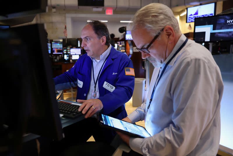 Traders work on the trading floor at the New York Stock Exchange (NYSE) in Manhattan, New York City