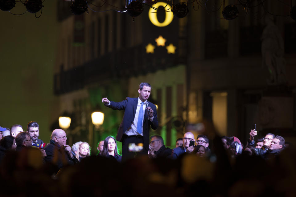 The leader of Venezuela's political opposition Juan Guaido addresses the crowd in the Puerta del Sol square during a visit to Madrid, Spain, Saturday, Jan. 25, 2020. Juan Guaido, the man who one year ago launched a bid to oust Venezuelan President Nicolas Maduro, arrived Saturday in Spain, where a thriving community of Venezuelans and a storm among Spanish political parties awaited him.(AP Photo/Paul White)