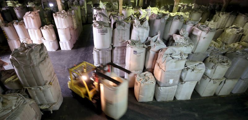 FILE PHOTO: A worker transports 1-tonne super sacks with coffee beans for export at a coffee warehouse in Santos