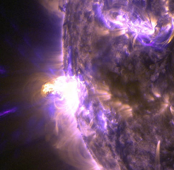 A moderate flare erupted on the sun, Aug. 24, 2014, shown in this image showing light in the 131 and 171 Angstrom wavelengths. The shorter wavelength, normally colorized in teal, highlights the extremely hot material of a flare. The longer wave