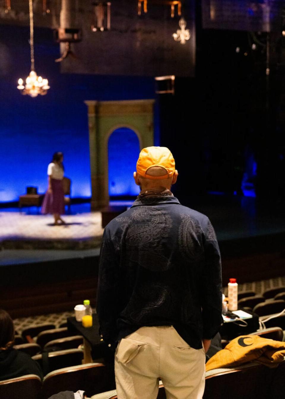 Nilo Cruz watches a technical rehearsal of his play “Two Sisters and a Piano” at Miami New Drama.