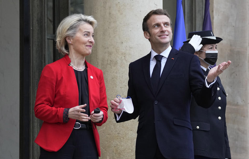 French President Emmanuel Macron, center, speaks with European Commission President Ursula von der Leyen during an official greeting at the Elysee Palace in Paris, France, Friday, Jan. 7, 2022. France took over the helm of the six month presidency of the Council of the European Union on Jan. 1, 2022. (AP Photo/Michel Euler)