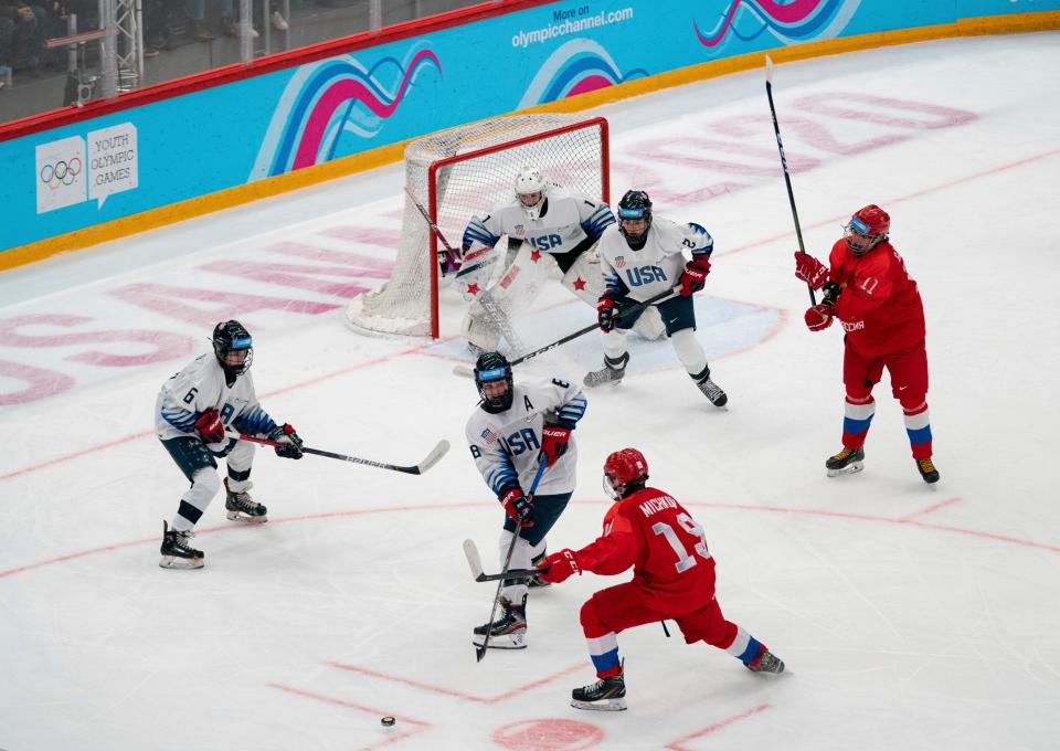 In this photo provided by the IOC, Russia's Matvei Michkov (19) attacks the USA end defended by USA's Lane Hutson (6) and Maddox Fleming (8) during an ice hockey men's match at the 2020 Winter Youth Olympic Games at Vaudoise Arena in Lausanne, Switzerland, Wednesday, Jan. 22, 2020. (Thomas Lovelock for OIS via AP)