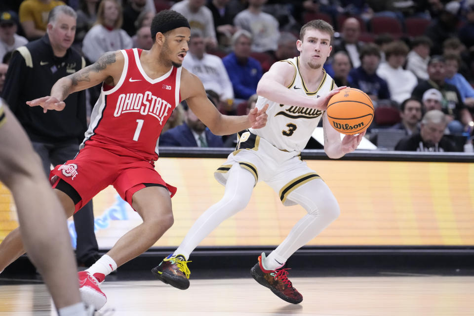 Purdue's Braden Smith (3) passes against Ohio State's Roddy Gayle Jr. (1) during the second half of an NCAA semifinal basketball game at the Big Ten men's tournament, Saturday, March 11, 2023, in Chicago. (AP Photo/Charles Rex Arbogast)