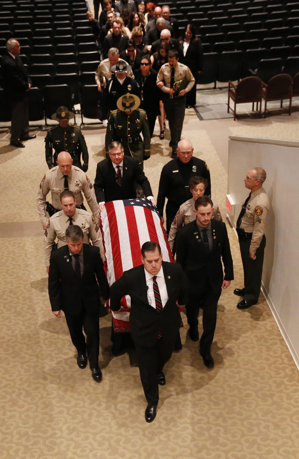 The casket with the body of Ventura County Sheriff Sgt. Ron Helus is carried out after a memorial service for Sgt. Helus at Calvary Community Church in Westlake Village, Calif., Thursday, Nov. 15, 2018. Sgt. Helus was one of twelve victims of the Borderline Bar & Grill mass shooting in Thousand Oaks last week. (Al Seib /Los Angeles Times via AP, Pool)