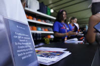 A sign announcing upgrades for crypto currency users is shown at a shop at the Formula One Miami Grand Prix auto race at Miami International Autodrome, Sunday, May 8, 2022, in Miami Gardens, Fla. (AP Photo/Wilfredo Lee)