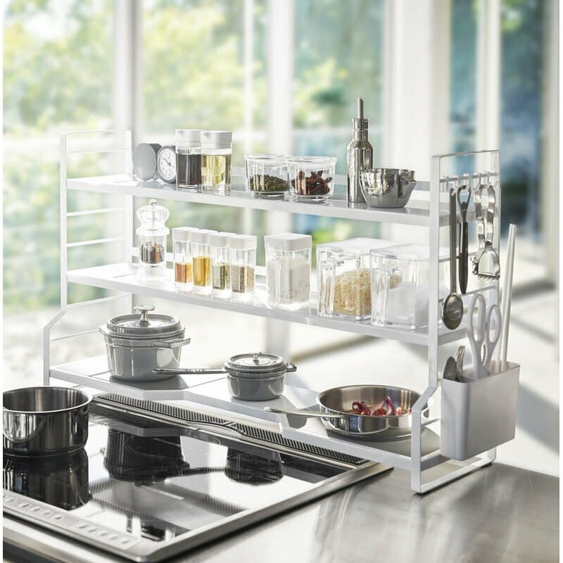 If you have the right kitchen setup, use <a href="https://fave.co/3jxPywo" target="_blank" rel="noopener noreferrer">this countertop pot rack</a> to create tons of space around your stovetop. This rack includes storage for pots and pans on the bottom (the gray pads double as trivets!), and the top two shelves can be used for lids, spices or whatever else you might need handy. Keep kitchen scissors and utensils within reach with the attached basket on the side. Buy <a href="https://amzn.to/35Im4XI" target="_blank" rel="noopener noreferrer">a few small S-hooks</a>, and you can hang measuring cups, wooden spoons and other gadgets from the sides. <a href="https://fave.co/3jxPywo" target="_blank" rel="noopener noreferrer">Get it for $69 at Wayfair</a>.