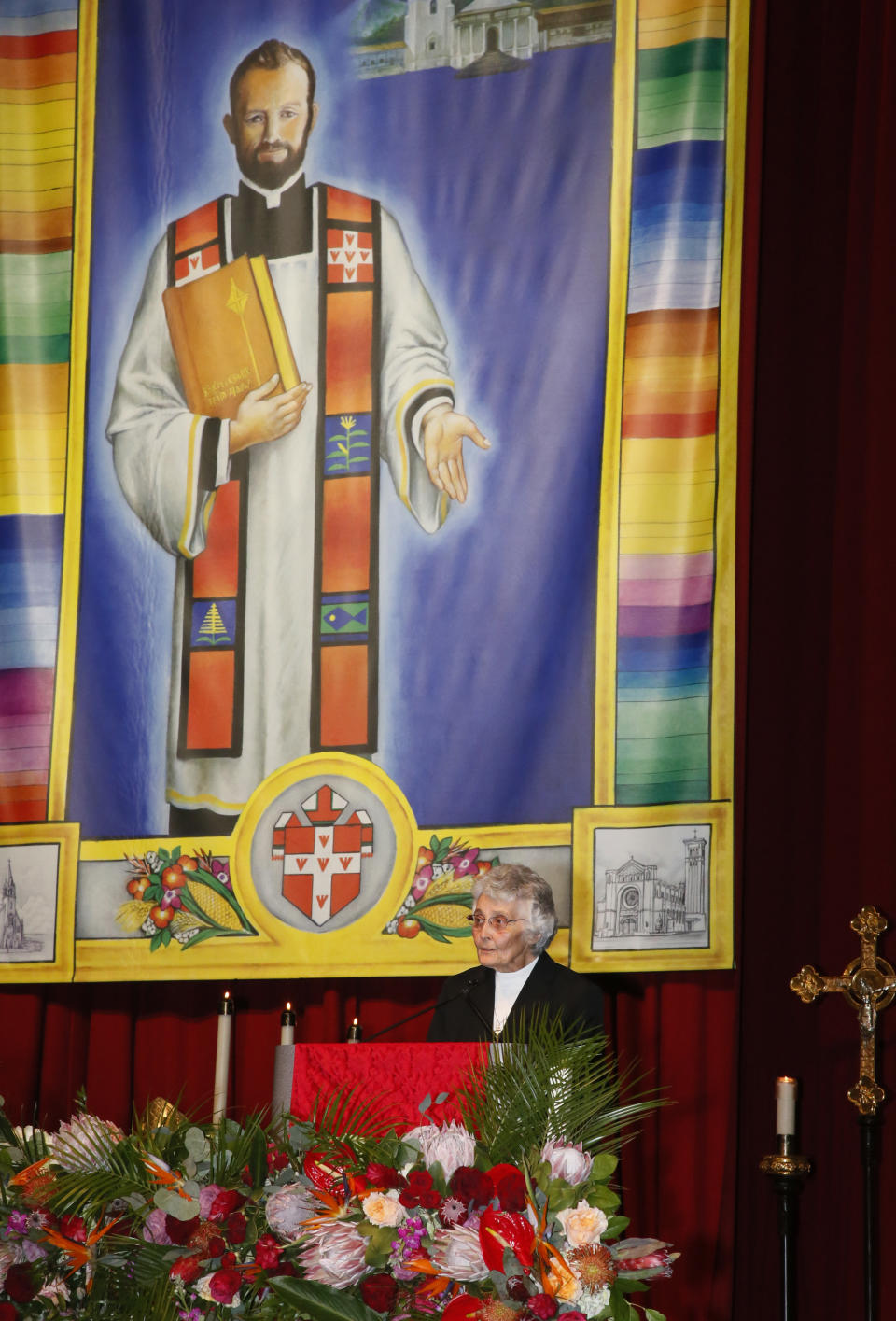 FILE - Sister Marita Rother gives a reading during Mass during the Beatification Ceremony for her brother, Blessed Stanley Rother, in Oklahoma City, Saturday, Sept. 23, 2017. At rear is a large banner with the image of Blessed Stanley Rother. The 46-year-old priest, shot to death in 1981, became the Catholic Church’s first martyr to be born in the United States. Now a $50 million shrine built to honor the slain missionary is expected to draw thousands of pilgrims to his home state. (AP Photo/Sue Ogrocki, File)