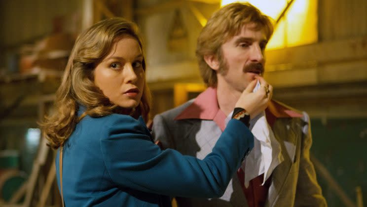 Brie Larson wiping just a few inches away from co-star Sharlto Copley’s fine mustache in <em>Free Fire</em>. (Photo: A24/courtesy Everett Collection)