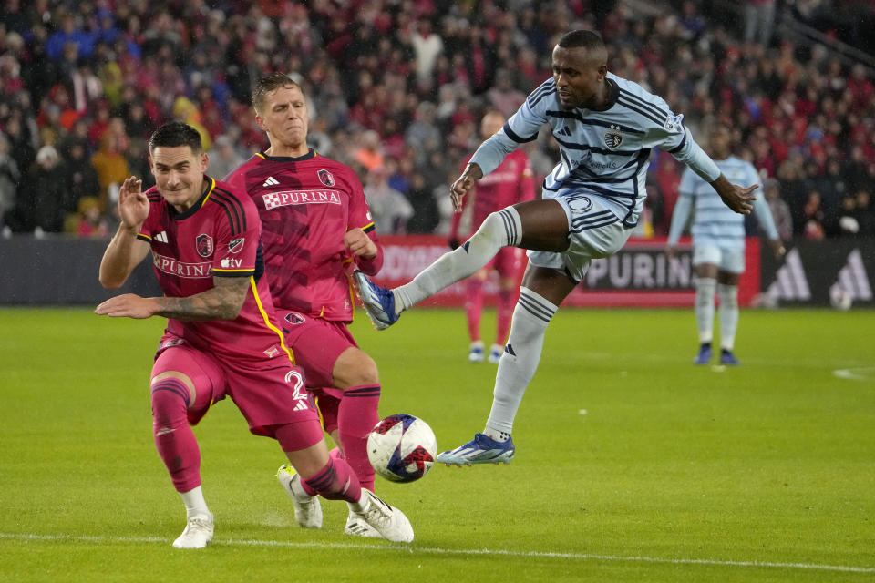 Sporting Kansas City midfielder Gadi Kinda (10) kicks past St. Louis City defender Jake Nerwinski (2) to score a goal during the first half of an MLS playoff soccer match Sunday, Oct. 29, 2023, in St. Louis. (AP Photo/Jeff Roberson)