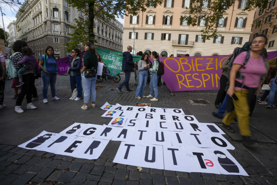 People stage a protest on 'International Safe Abortion Day' to ask for more guarantees on the enforcement of the abortion law that they claim is seriously endangered by the high rate of doctors' conscientious objection in the country, in Rome, Wednesday, Sept. 28, 2022. Banner on the ground reads "Safe and free abortion for all". (AP Photo/Alessandra Tarantino)