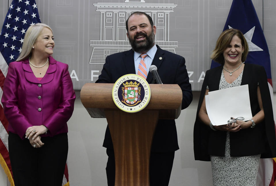 Puerto Rico's Governor Wanda Vazquez, holds a press conference where she announces the appointments of Eli Diaz Atienza, center, and Zoe Laboy, right, at the governor's official residence La Fortaleza in San Juan, Puerto Rico, Wednesday, Aug. 21, 2019. Vazquez appointed Senator Zoe Laboy as Chief of Staff, and the Executive Director of the Aqueduct and Sewer Authority Eli Diaz Atienza as representative on the Federal Board of Fiscal Control. (AP Photo/Carlos Giusti)