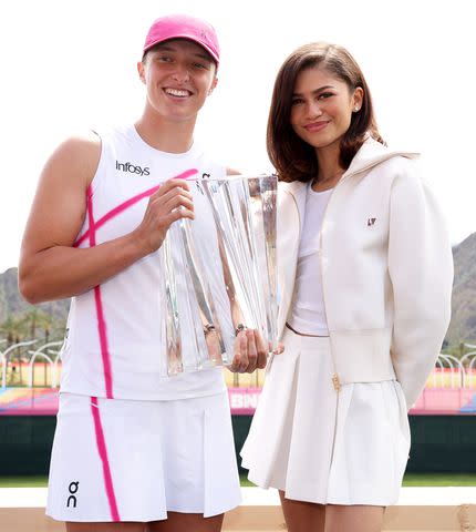 <p>Clive Brunskill/Getty Images</p> Iga Swiatek pictured with Zendaya after winning at the women's final during the BNP Paribas Open