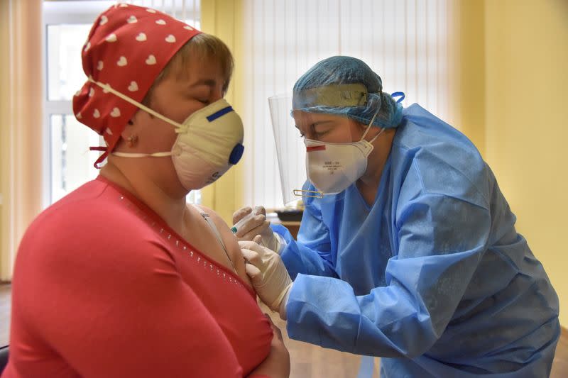 A medical worker receives a dose of the AstraZeneca vaccine against the coronavirus disease in Lviv