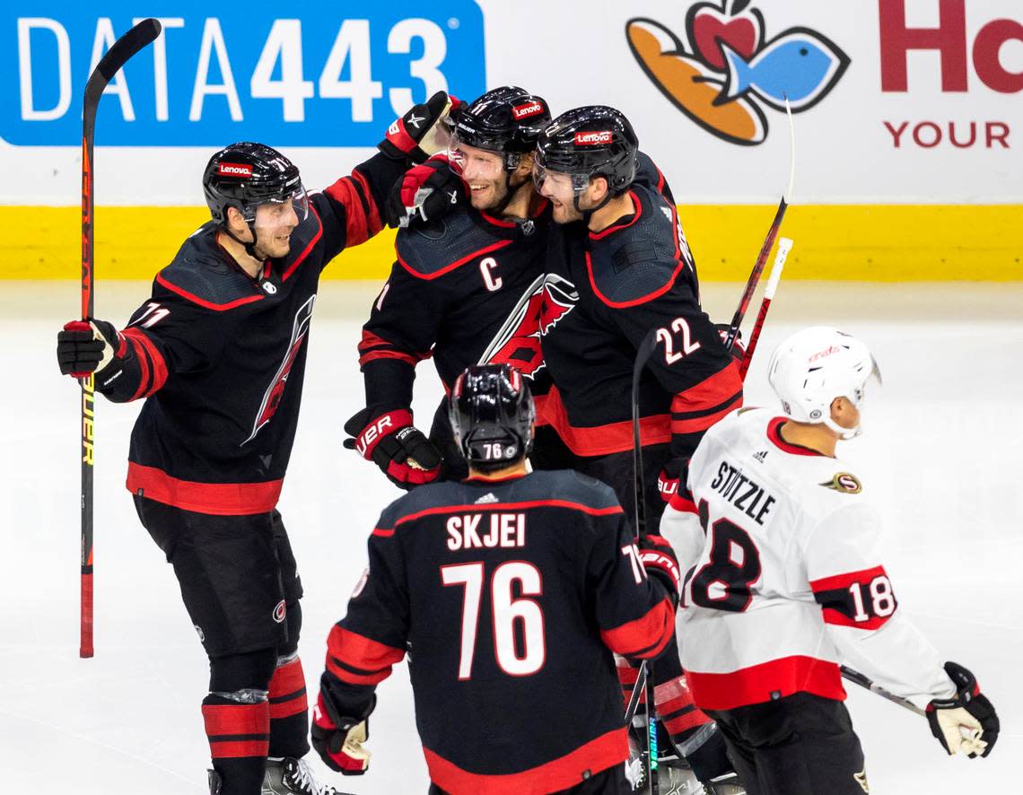 The Carolina Hurricanes Jesper Fast (71) and Brett Pesce (22) celebrate with Jordan Staal (11) after his goal in the third period on Wednesday, October 11, 2023 at PNC Arena, in Raleigh N.C. Robert Willett/rwillett@newsobserver.com