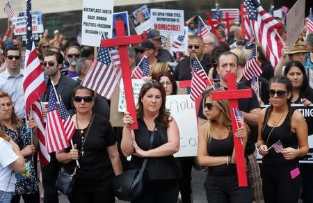 Protesters rally outside the federal court just before a hearing to consider a class-action lawsuit filed on behalf of Iraqi nationals facing deportation, in Detroit, Michigan, U.S., June 21, 2017. REUTERS/Rebecca Cook