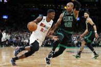 Miami Heat's Jimmy Butler (22) drives past Boston Celtics' Al Horford (42) during the second half of an NBA basketball game Friday, Dec. 2, 2022, in Boston. (AP Photo/Michael Dwyer)