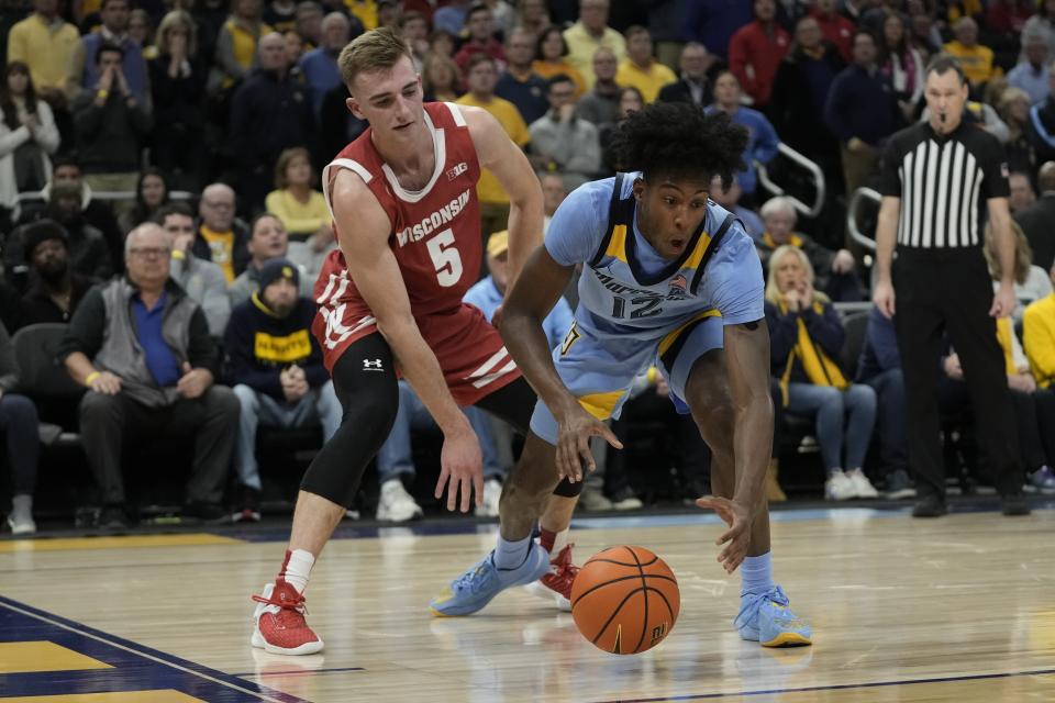 Wisconsin's Tyler Wahl knock the ball from Marquette's Olivier-Maxence Prosper during the overtime of an NCAA college basketball game Saturday, Dec. 3, 2022, in Milwaukee. Wisconsin won 80-77 in overtime. (AP Photo/Morry Gash)