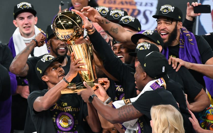 ORLANDO, FLORIDA OCTOBER 11, 2020-Lakers Rajon Rondo holds the trophy.