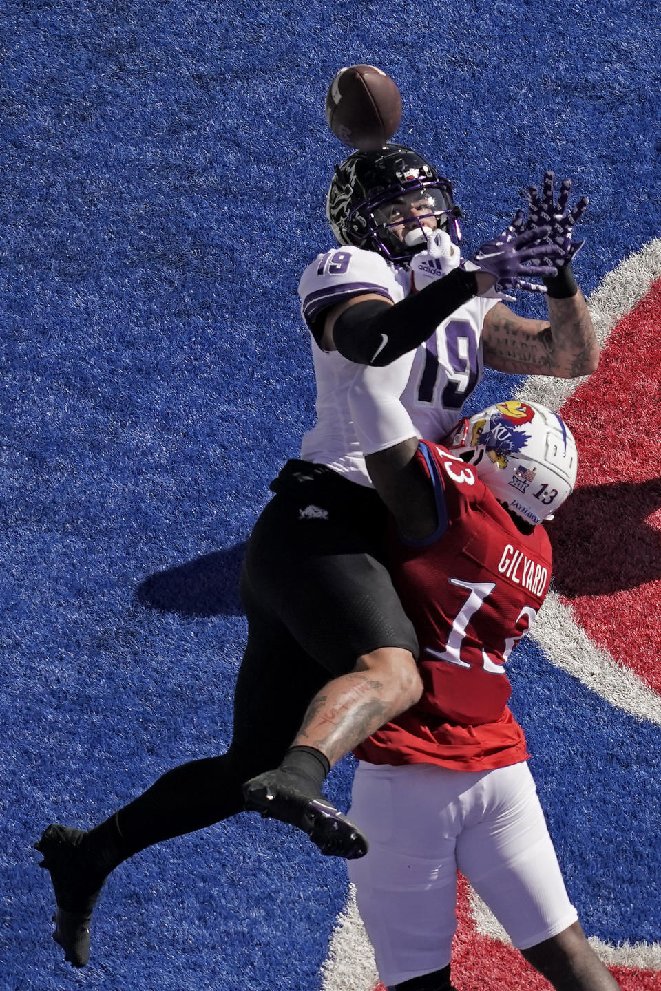 Kansas linebacker Eriq Gilyard (13) breaks up a pass intended for TCU tight end Jared Wiley (19) during the first half of an NCAA college football game Saturday, Oct. 8, 2022, in Lawrence, Kan. (AP Photo/Charlie Riedel)
