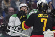 Vancouver Canucks' Carson Soucy, front right, shoves Dallas Stars' Joe Pavelski during the second period of an NHL hockey game Thursday, March 28, 2024, in Vancouver, British Columbia. (Darryl Dyck/The Canadian Press via AP)