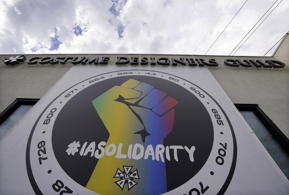 A poster advocating union solidarity hangs from a Costume Designers Guild office building, Monday, Oct. 4, 2021, in Burbank, Calif. The International Alliance of Theatrical Stage Employees (IATSE) overwhelmingly voted to authorize a strike for the first time in its 128-year history. (AP Photo/Chris Pizzello)