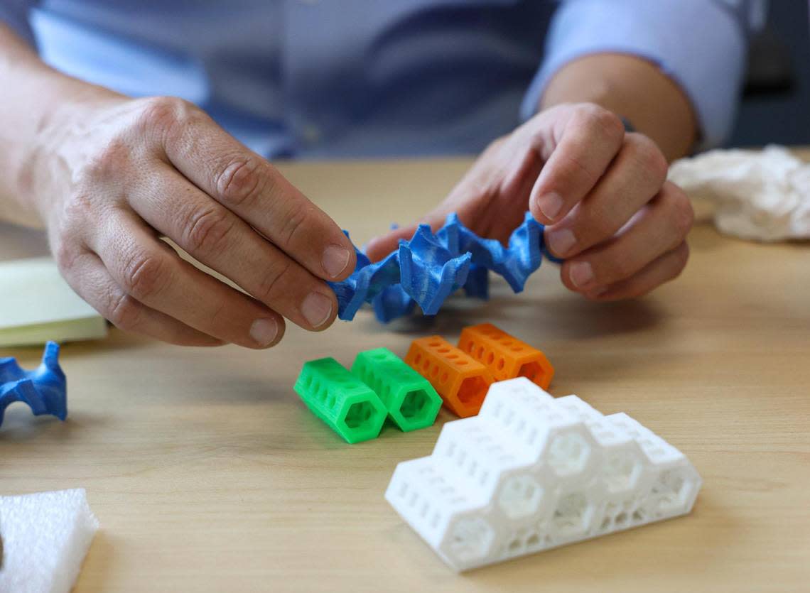 University of Miami marine biology and ecology professor Andrew Baker demonstrates how different designs for artificial reef structures might fit together.