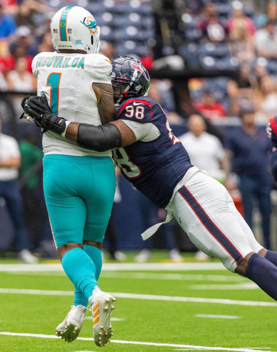 Aug 19, 2023; Houston, Texas, USA; Miami Dolphins quarterback Tua Tagovailoa (1) is hit by Houston Texans defensive tackle Sheldon Rankins (98) after throwing the ball in the first quarter at NRG Stadium. Mandatory Credit: Thomas Shea-USA TODAY Sports Thomas Shea/Thomas Shea-USA TODAY Sports