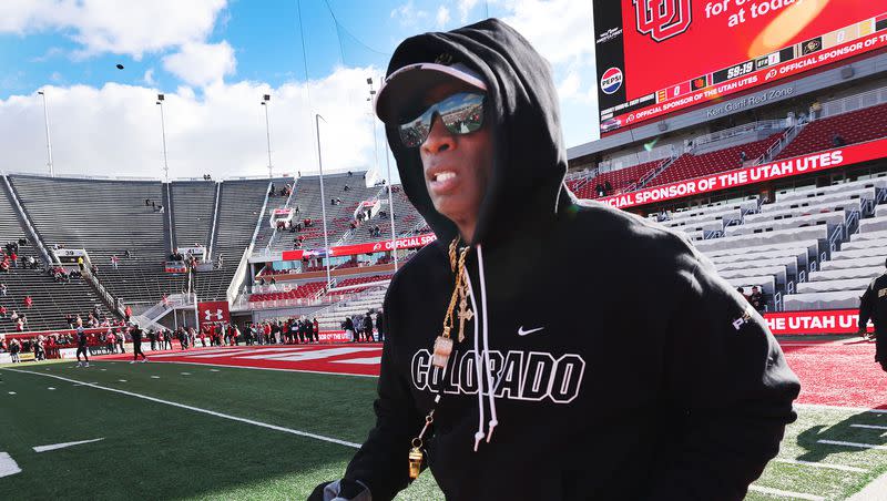 Colorado Buffaloes head coach Deion Sanders runs onto the field in Salt Lake City on Saturday, Nov. 25, 2023.