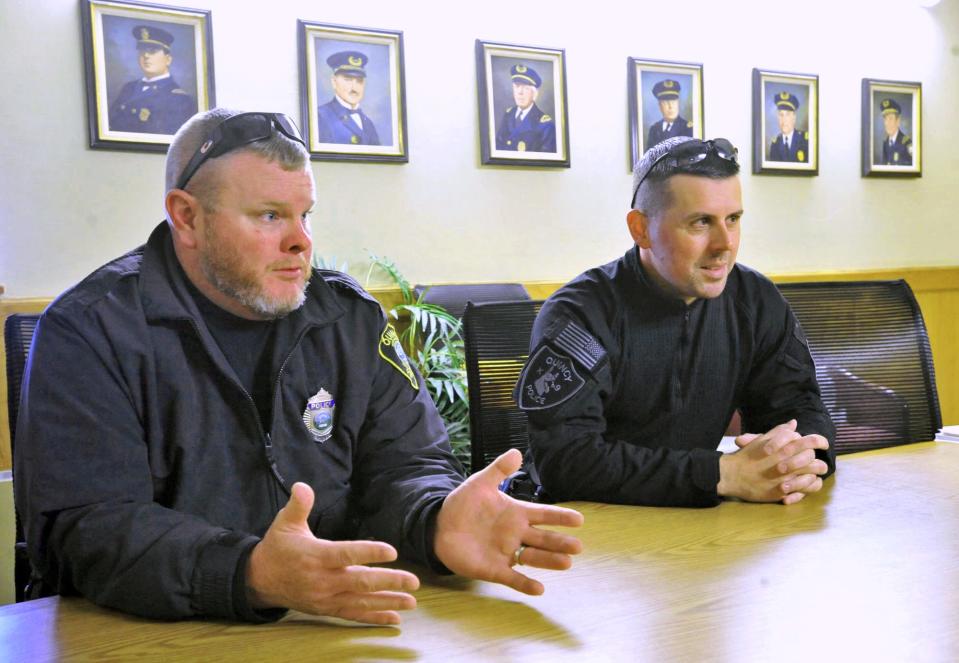 Quincy police officers Michael Brokmeier, left, and Sean Fitzgerald, right, describe their harrowing rescue of a man from his burning home in West Quincy in August.