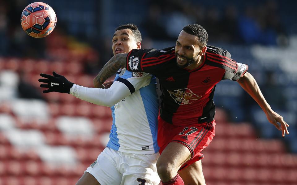 Blackburn Rovers' Joshua King (L) is fouled by Swansea City's Kyle Bartley, resulting in a red card for Bartley, during their FA Cup fourth round soccer match at Ewood Park in Blackburn, northern England January 24, 2015. REUTERS/Andrew Yates (BRITAIN - Tags: SPORT SOCCER TPX IMAGES OF THE DAY)