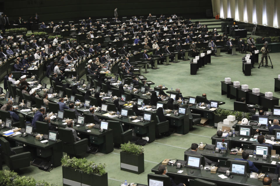 The Iranian parliament debates the proposed ministers of President Ebrahim Raisi's new cabinet, in Tehran, Iran, Wednesday, Aug. 25, 2021. Iran's hard-liner dominated parliament Wednesday voted to approve most of the proposed ministers by the recently elected president. (AP Photo/Vahid Salemi)