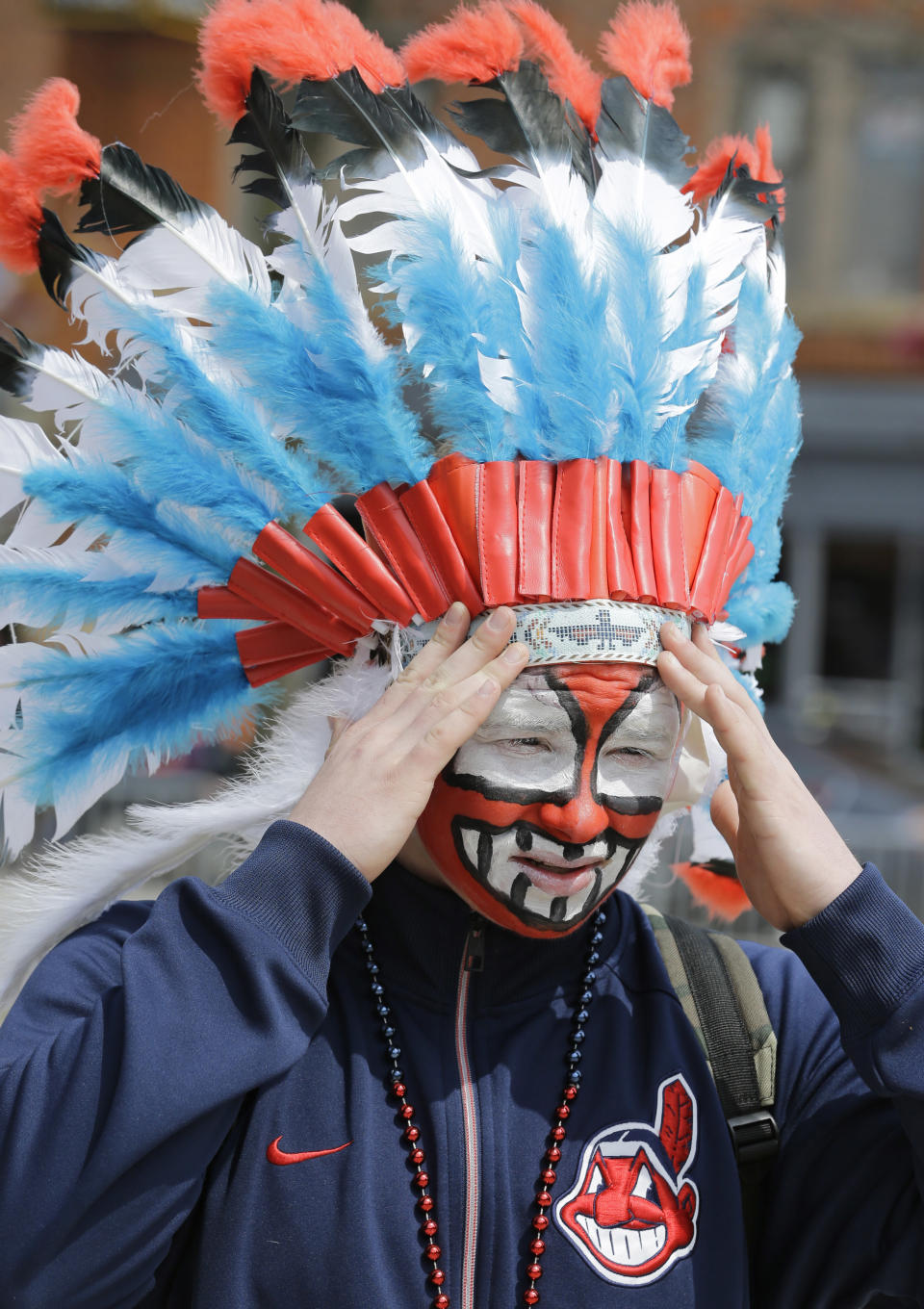 Austin Howell, 15, adjusts his headdress before a baseball game between the Chicago White Sox and the Cleveland Indians, Tuesday, April 11, 2017, during opening day in Cleveland. (AP Photo/Tony Dejak)