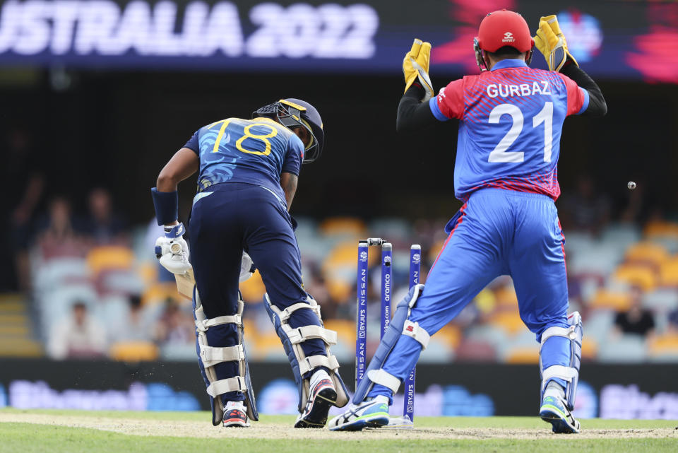 ISri Lanka's Pathum Nissanka looks back to see he is out bowled by Afghanistan's Mujeeb Ur Rahman during the T20 World Cup cricket match between Afghanistan and Sri Lanka, in Brisbane, Australia, Tuesday, Nov. 1, 2022. (AP Photo/Tertius Pickard)