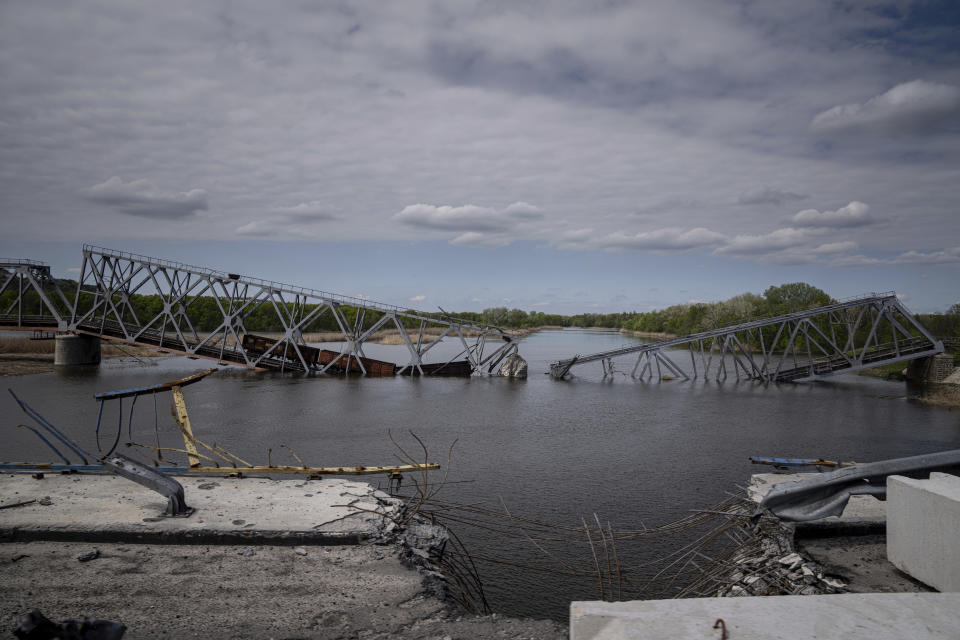 A view of a destroyed railway bridge over Siverskiy Donets river near Raigorodka, Donetsk region, eastern Ukraine, Saturday, April 30, 2022. (AP Photo/Evgeniy Maloletka)