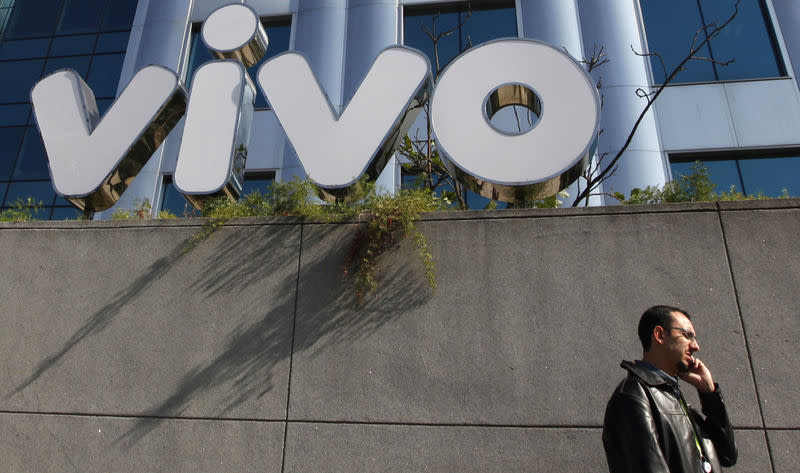 A man speaks on his mobile phone outside the headquarters of Vivo in Sao Paulo June 30, 2010. REUTERS/Nacho Doce/Files