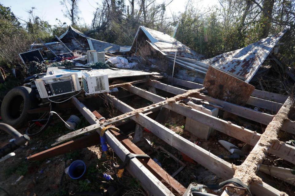 The foundation for what once was a mobile home, littered with debris and belongings after being ripped to shreds by Hurricane Michael in Oct. 2018. 