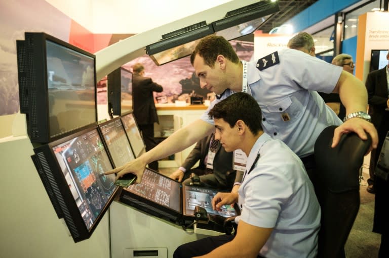 Navy pilots try a flight simulator during the LAAD 2017 Defence and Security expo, in Rio de Janeiro, Brazil