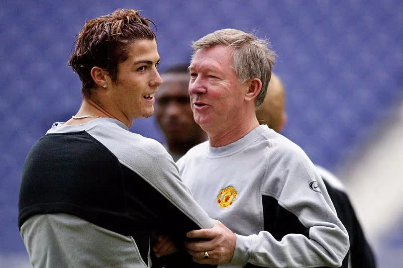 Manchester United manager Sir Alex Ferguson (R) with Manchester United's striker Cristiano Ronaldo (L) at the training session at the Dragon stadium in Porto 24 February 2004. The training session is a day a head of the clash between FC Porto and Manchester United for the UEFA Champions League first group, knock out round, first leg.