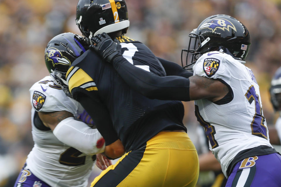 Pittsburgh Steelers quarterback Mason Rudolph (2) is hit by Baltimore Ravens free safety Earl Thomas (29), left, and cornerback Brandon Carr (24) during the second half of an NFL football game, Sunday, Oct. 6, 2019, in Pittsburgh. (AP Photo/Don Wright)
