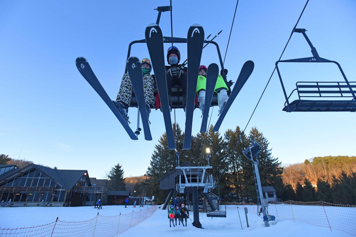 A trio of skiers take the lift to the top of Mount Mansfield at Snow Trails in Mansfield.