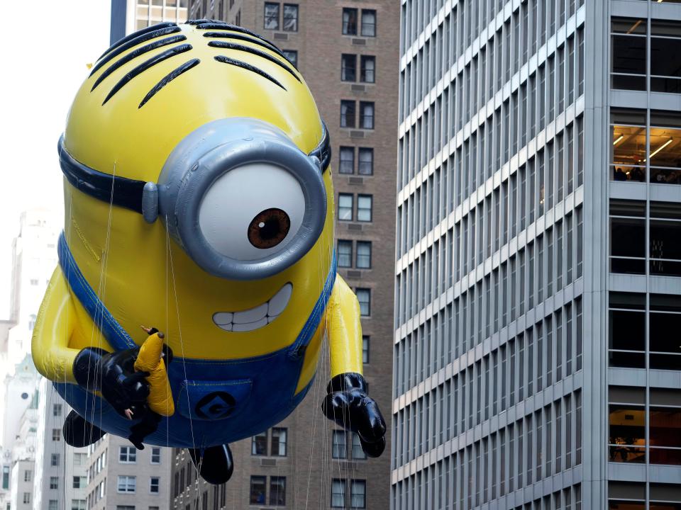 A minion balloon floats in the parade.