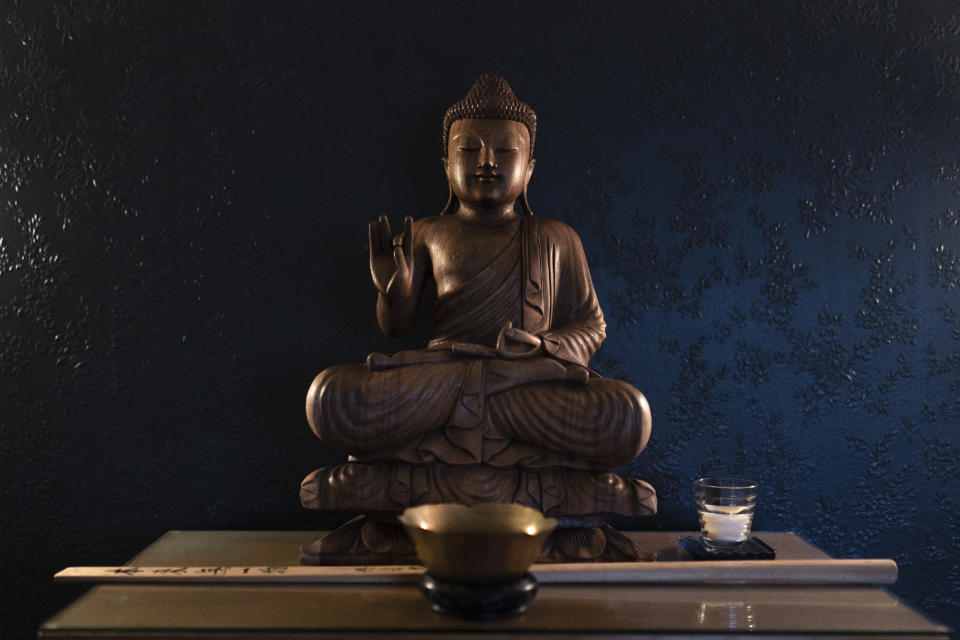 A Buddha statue sits on an altar at the Anchorage Zen Community in Anchorage, Alaska, Saturday, Oct. 8, 2022. Being Buddhist in Anchorage is both universal in practice and unique to life in Alaska. (AP Photo/Jae C. Hong)