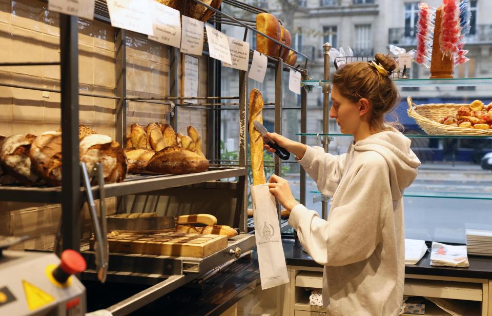 Inflation A staff member puts a French baguette into a bag at a bakery shop in Paris, France, Nov. 30, 2022. Artisanal know-how and culture of baguette bread was officially inscribed on the list of the Intangible Cultural Heritage of Humanity by the United Nations Educational, Scientific, and Cultural Organization UNESCO on Wednesday. (Photo by Gao Jing/Xinhua via Getty Images)