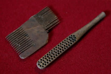 A Tudor comb and a Victorian toothbrush, which were excavated from the River Thames by mudlark Jason Sandy, are displayed at his home in London, Britain June 01, 2016. REUTERS/Neil Hall