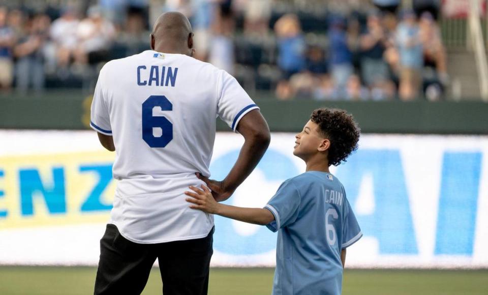 Cameron Cain, 8, comforts his dad and former Kansas City Royals center fielder Lorenzo Cain during a retirement ceremony at Kauffman Stadium on Saturday, May 6, 2023, in Kansas City. Cain signed a ceremonial one-day contract to retire as a Royal.