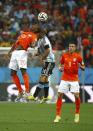 Georginio Wijnaldum (L) of the Netherlands and Argentina's Javier Mascherano collide as they jump for the ball during their 2014 World Cup semi-finals at the Corinthians arena in Sao Paulo July 9, 2014. REUTERS/Michael Dalder (BRAZIL - Tags: SOCCER SPORT WORLD CUP)