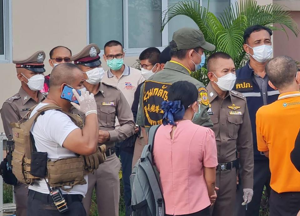 Thai police officers inspect the scene of the massacre (EPA)