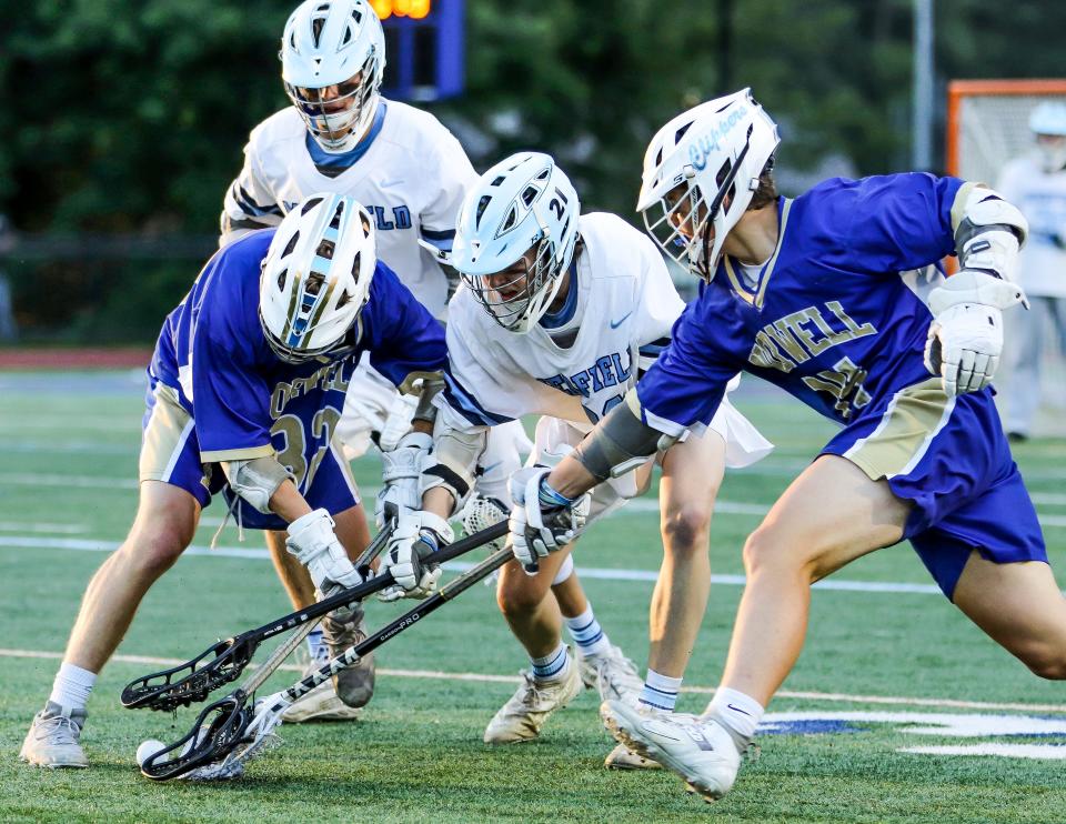 Norwell's Dylan McGuirk, left, and Ryan Shea battle for the ball during the Division 3 state title game against Medfield on the campus of Worcester State University on Wednesday, June 22, 2022.