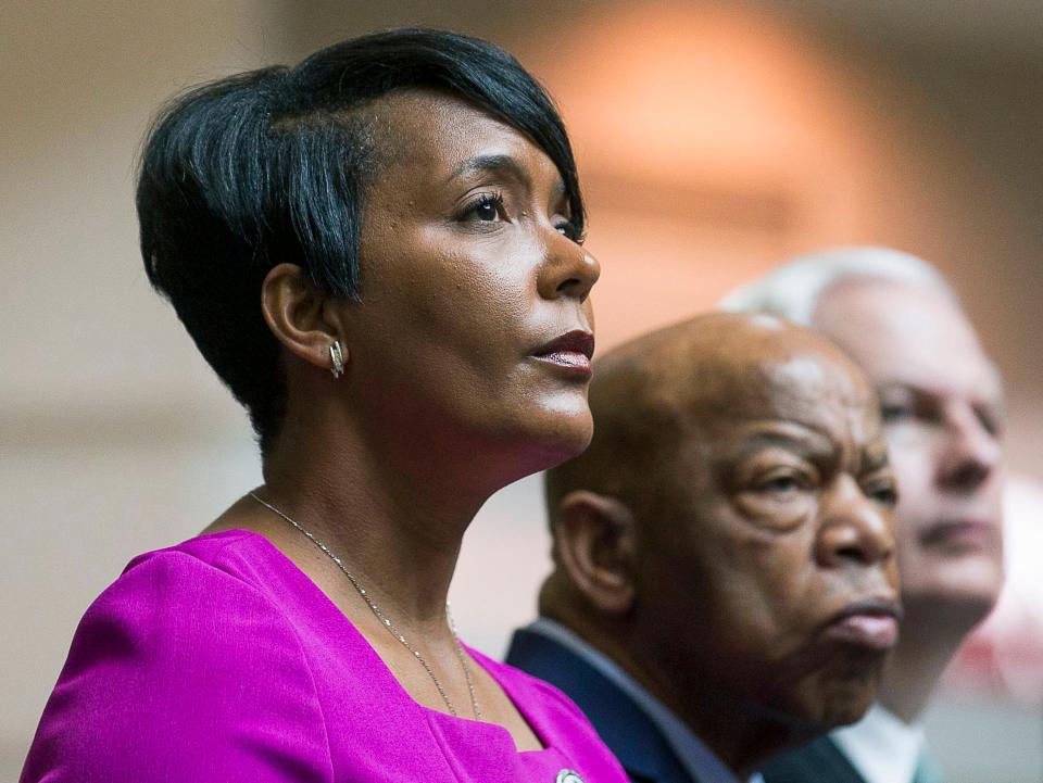 Atlanta Mayor Keisha Lance Bottoms, left, sits with U.S. Rep. John Lewis during a tribute to Lewis this month at Atlanta's Hartsfield Jackson International Airport. Some students at Spelman College aren’t happy that the mayor will be their commencement speaker this year.